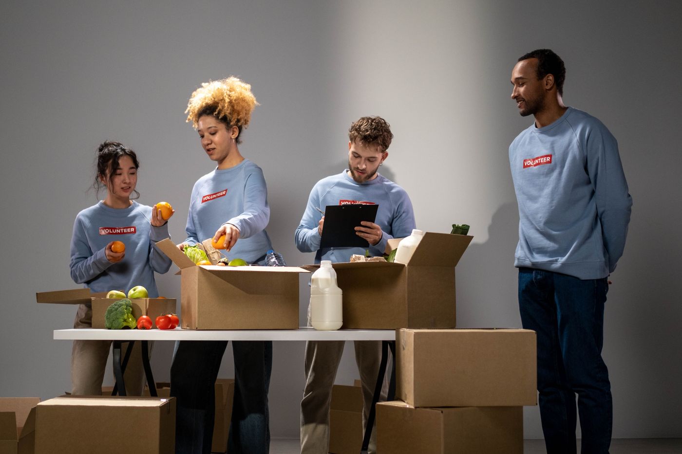 Volunteers packing food and essential-supply donations for families in need